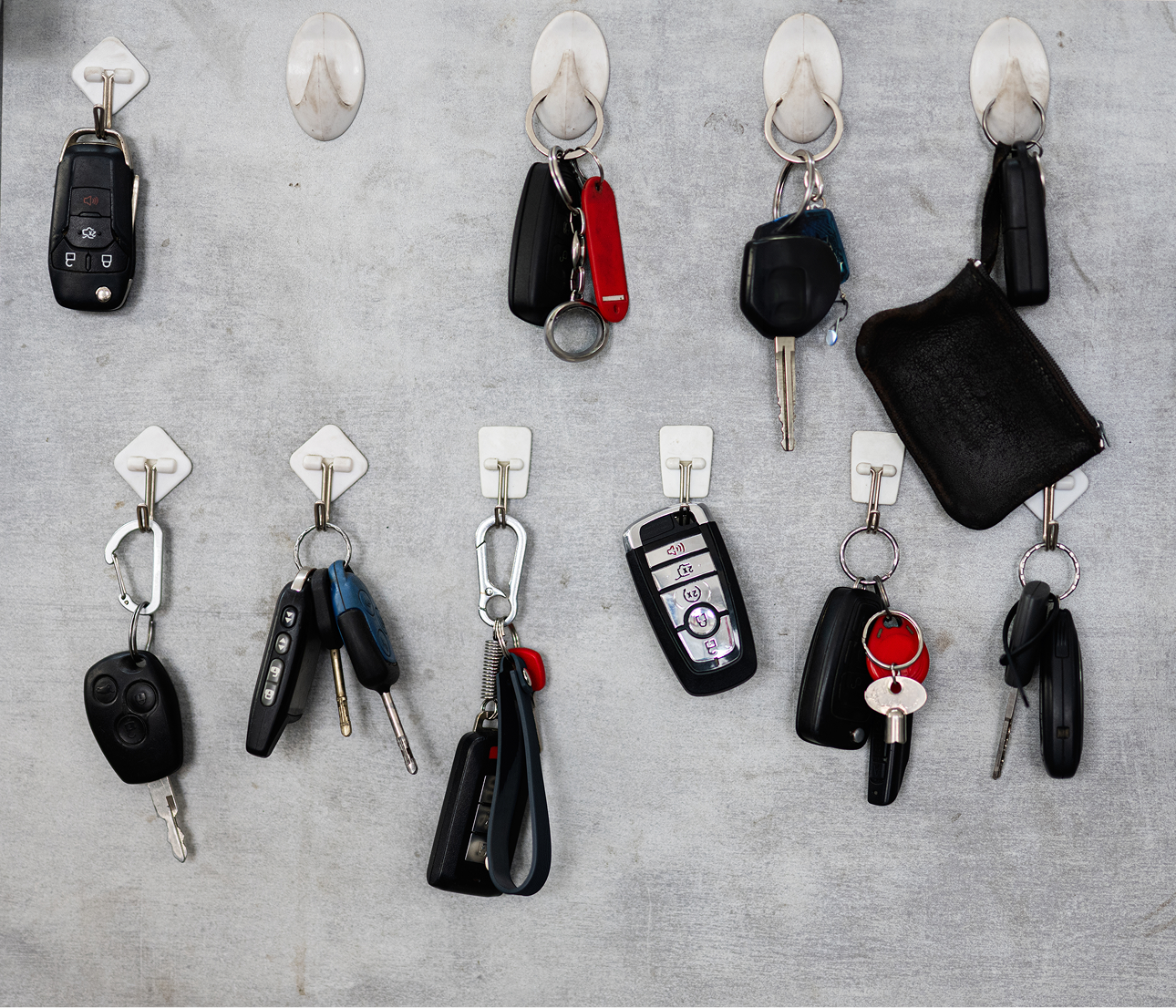 Car keys hanging on wall hooks.